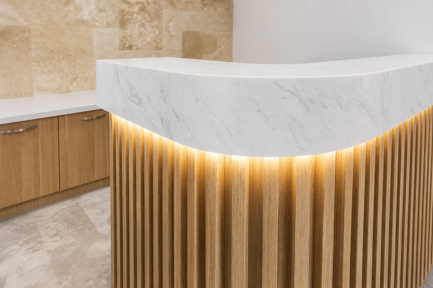 Curved white reception counter, oak battens and concealed light